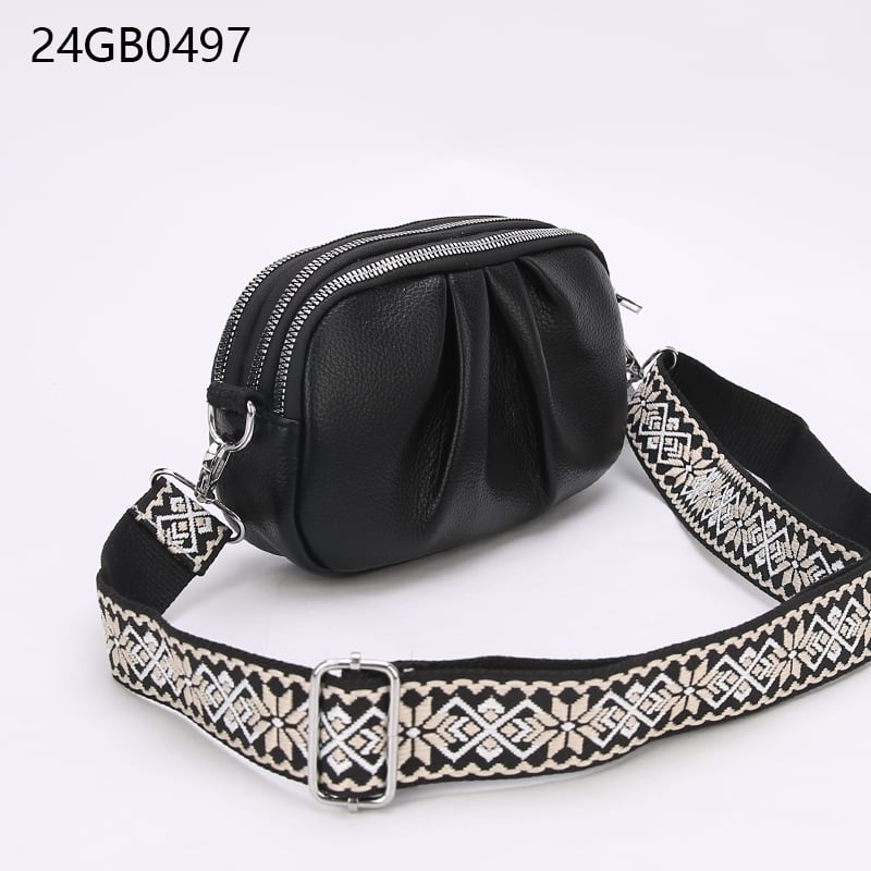 Faux leather cross body bag with patterned shoulder strap