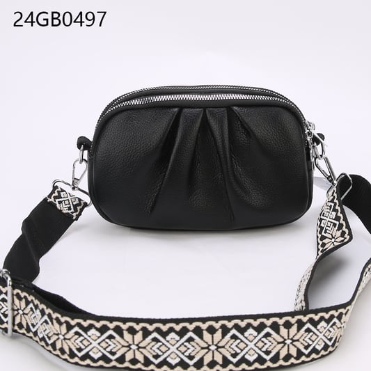 Faux leather cross body bag with patterned shoulder strap